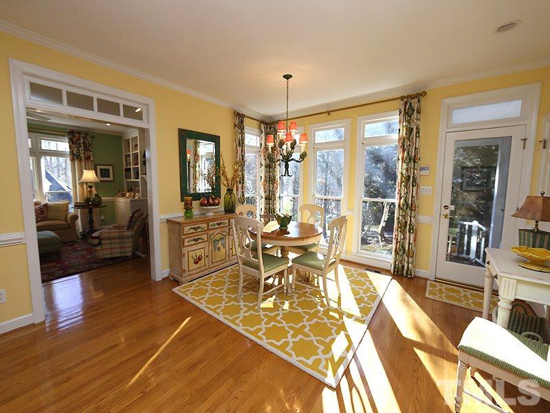 8808 Ross Court Raleigh, NC 27613 - Photo 3 of 25 a living room with furniture a dining table and a large window