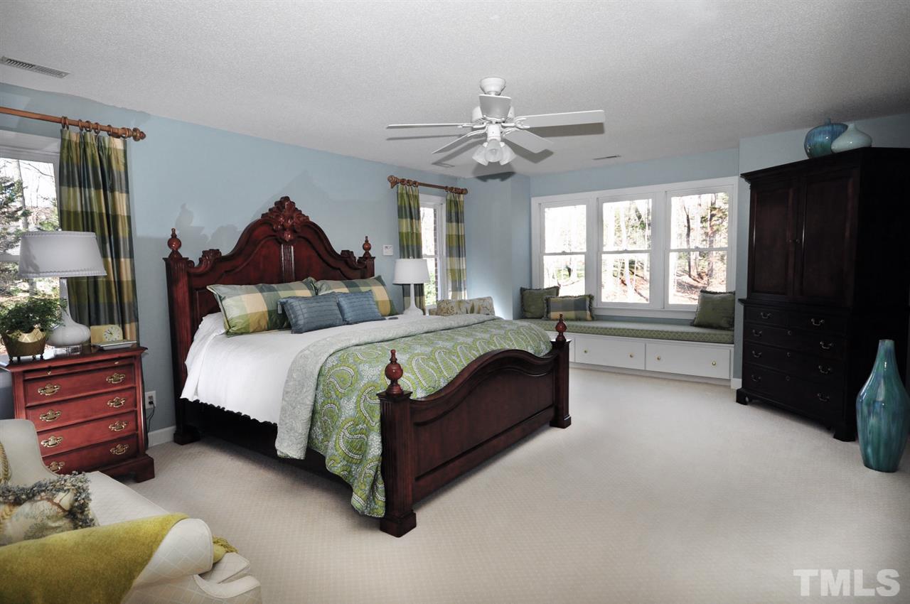 8808 Ross Court Raleigh, NC 27613 - Photo 10 of 25 a bedroom with a bed and a chandelier