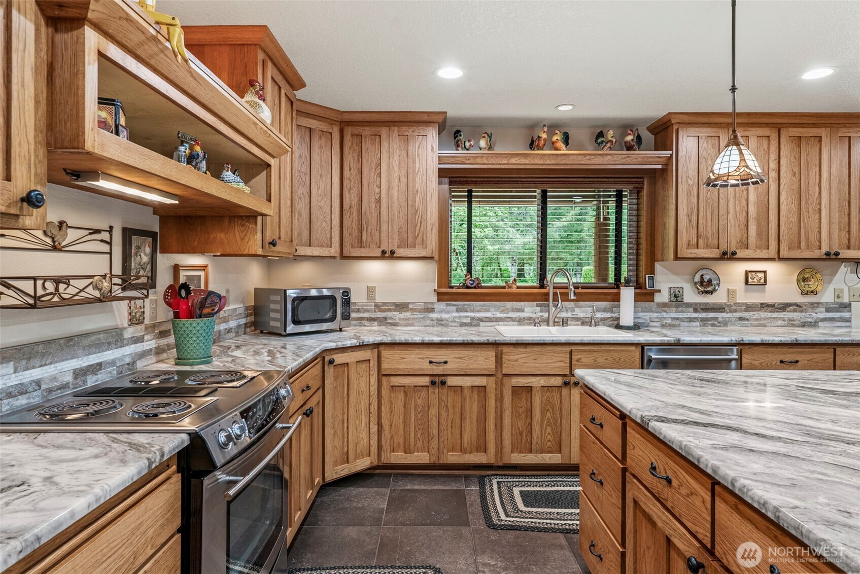 1579 Germany Creek Road Longview, WA 98632 - Photo 17 of 35 a kitchen with kitchen island granite countertop a sink stove and cabinets