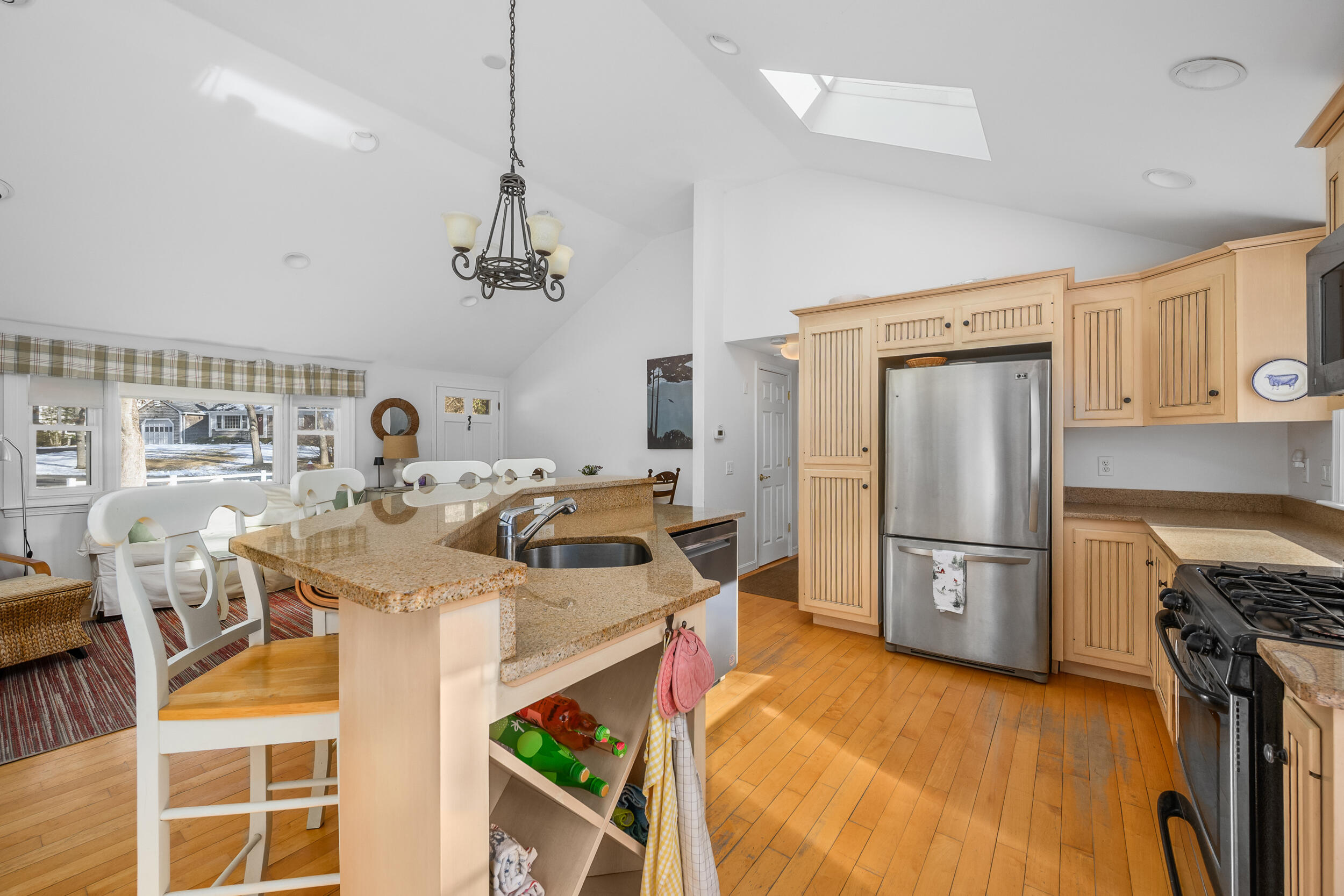 5 Chickadee Lane Centerville, MA 02632 - Photo 11 of 22 a kitchen with stainless steel appliances granite countertop a sink a stove a refrigerator cabinets and chairs