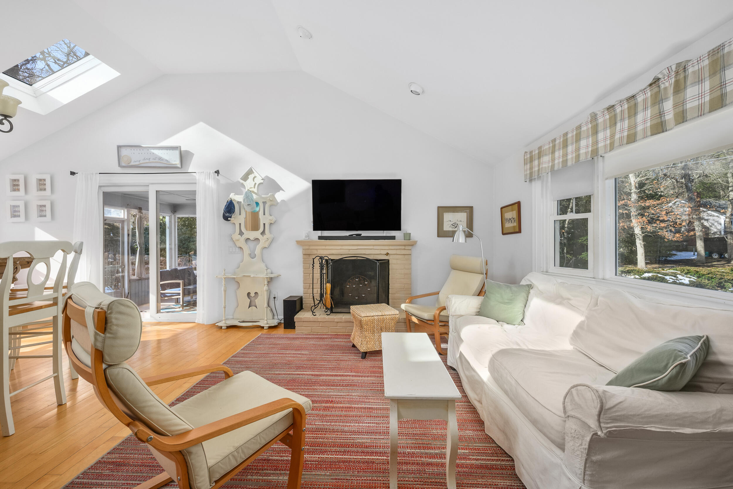 5 Chickadee Lane Centerville, MA 02632 - Photo 6 of 22 a living room with furniture a fireplace and a flat screen tv