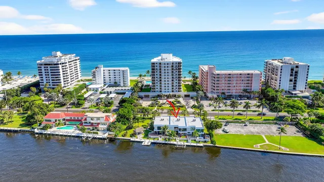 an aerial view of a house with a lake view