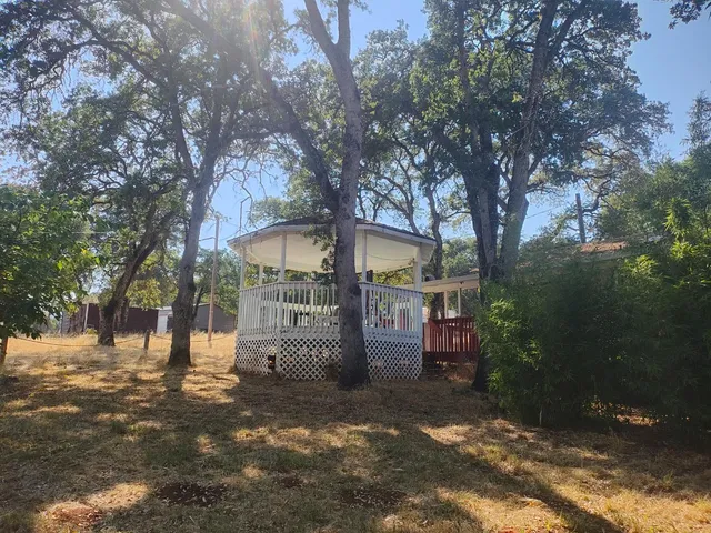 a backyard of a house with table and chairs