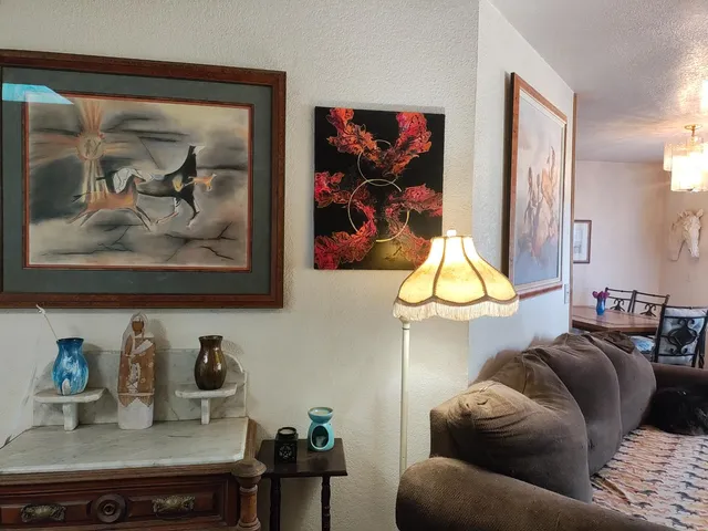 a kitchen with a refrigerator a stove and a sink with wooden floor