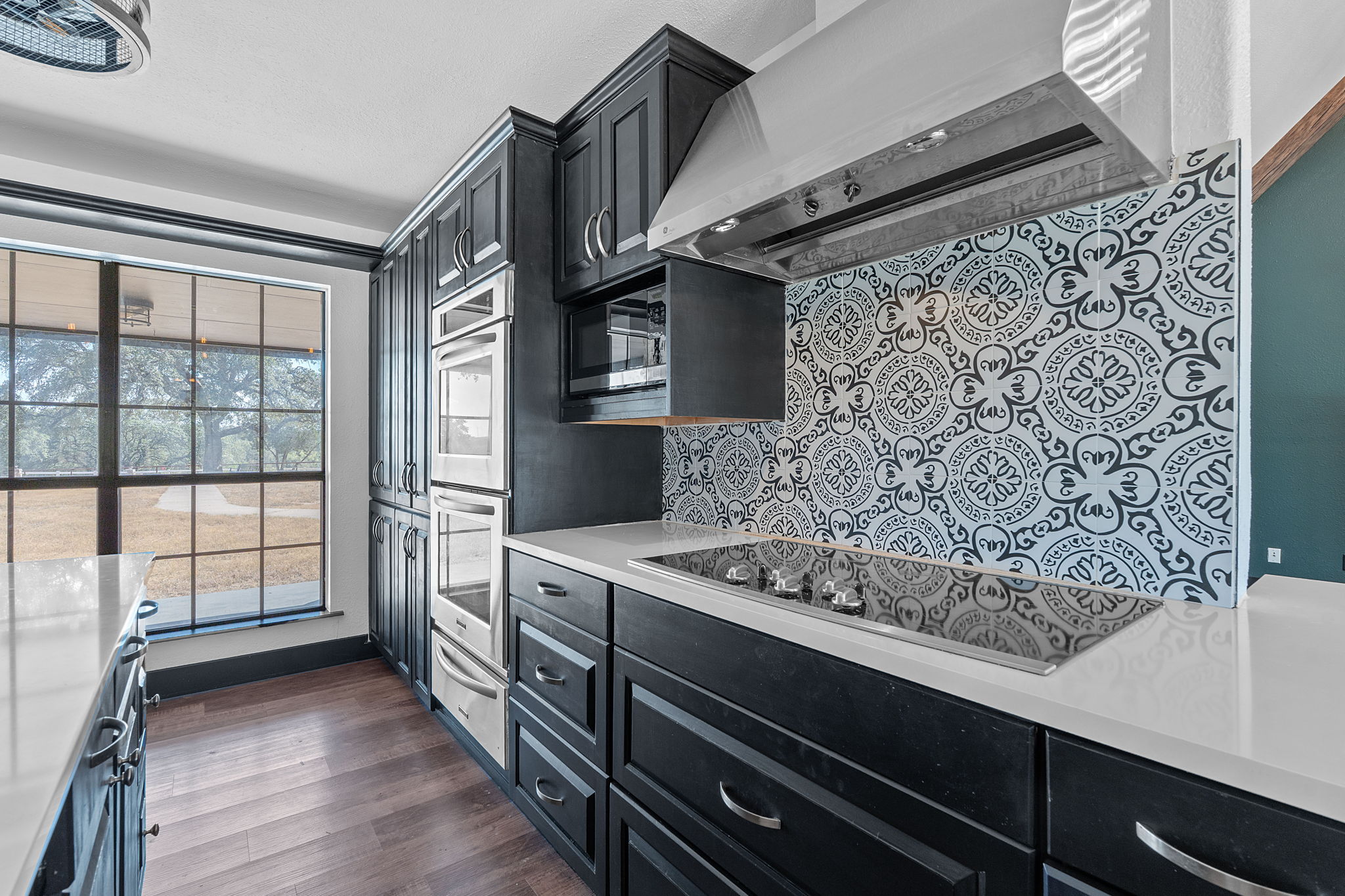 404 County Road 421 Spicewood, TX 78669 - Photo 11 of 31 a view of kitchen with stainless steel appliances cabinets and a large window