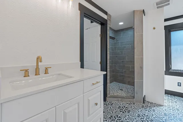 a bathroom with a sink a toilet and shower