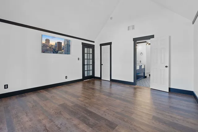 a view of a room with wooden floor and window