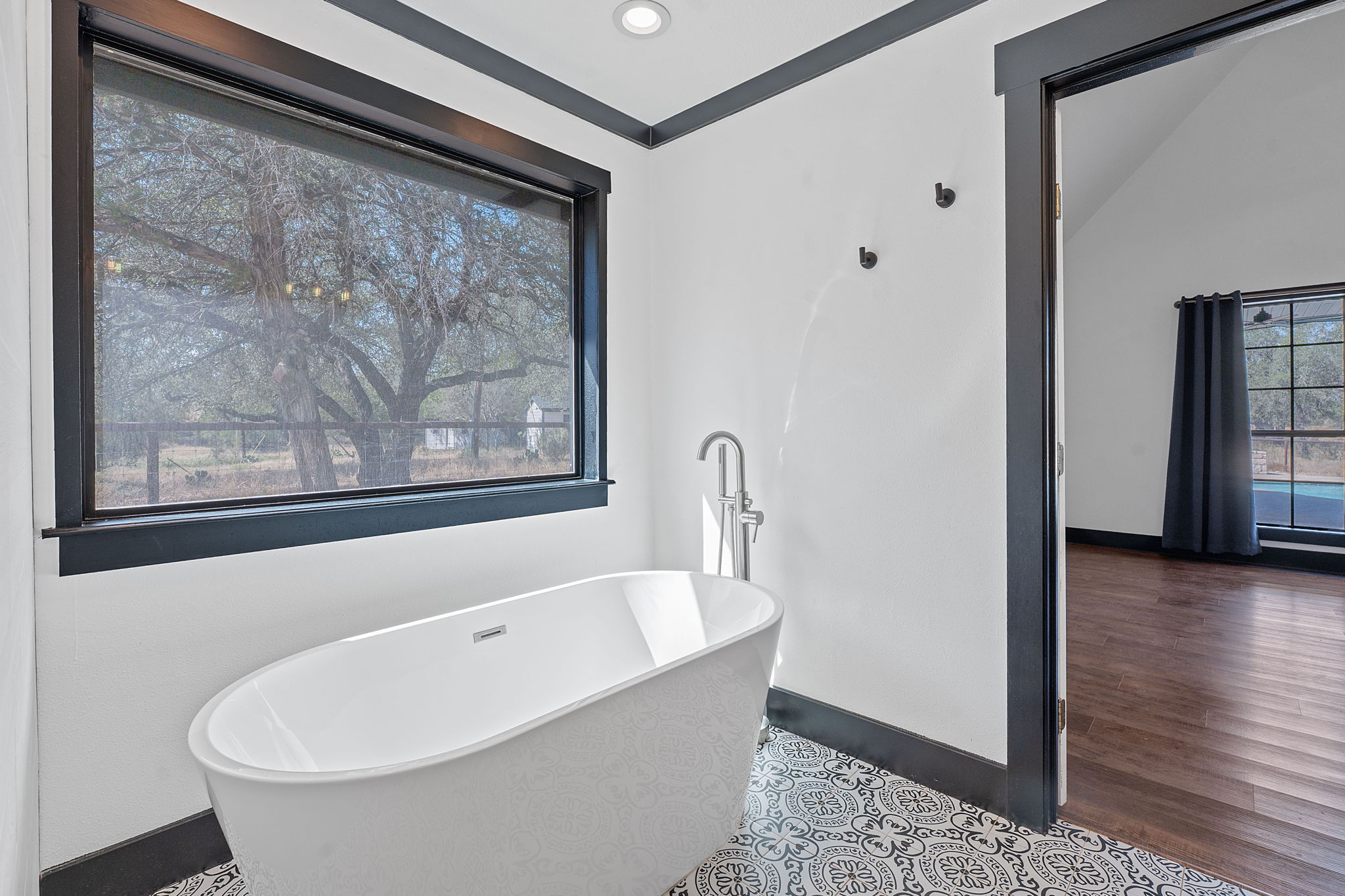 404 County Road 421 Spicewood, TX 78669 - Photo 21 of 31 a bathroom with a bathtub and a window