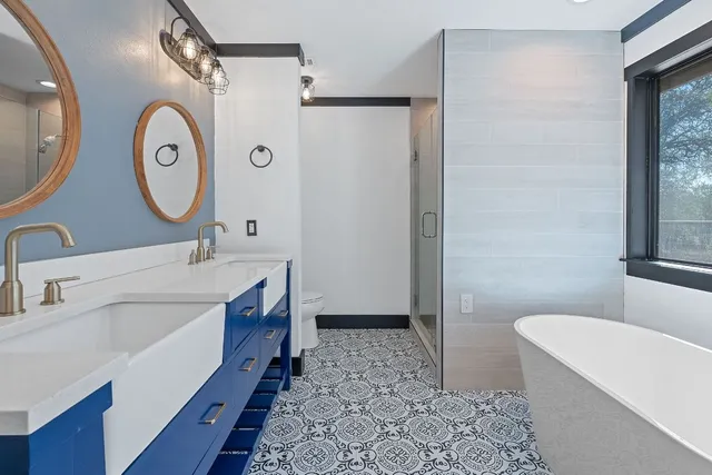 a bathroom with a tub sink and mirror
