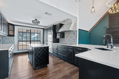 a view of kitchen with stainless steel appliances cabinets and a large window