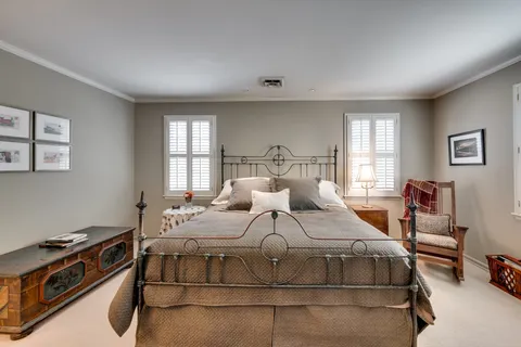 a bedroom with a bed a desk and chair