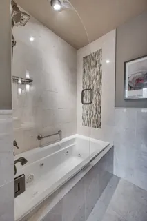 a spacious bedroom with a bed and a table in it