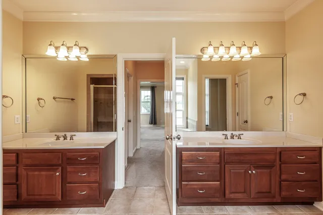 a bathroom with a double vanity sink mirror and double