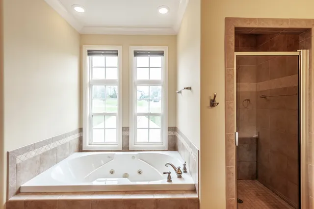 a bathroom with bathtub and window
