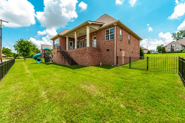 a view of a house with a yard and deck