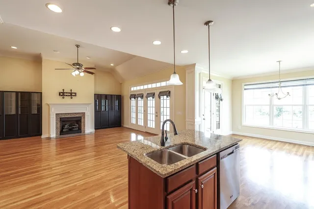 a kitchen with sink stove and wooden floor