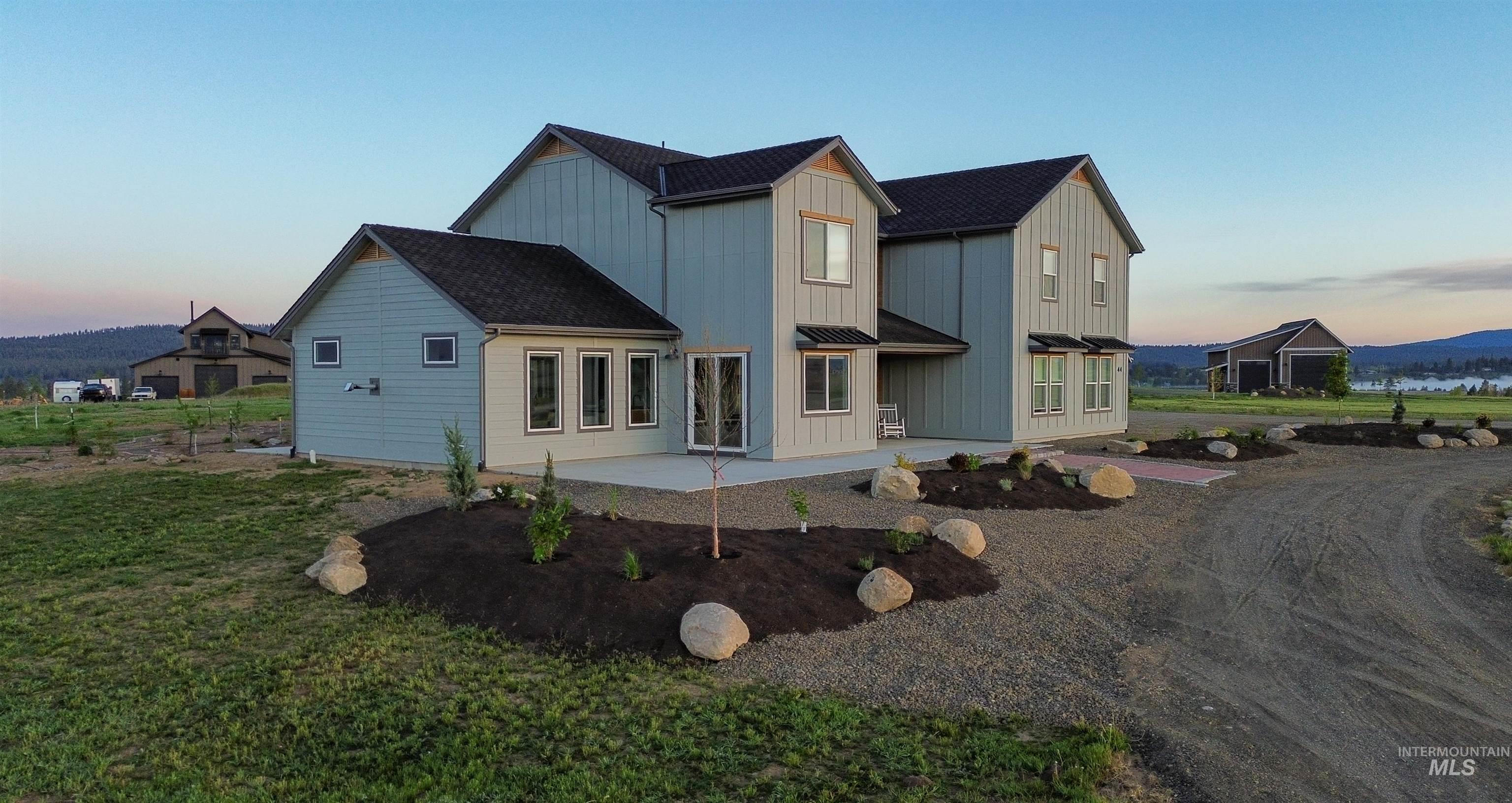 44 Big Moose Road McCall, ID 83638 - Photo 2 of 50 Contemporary two-story residence featuring light blue vertical siding and dark shingle roofing