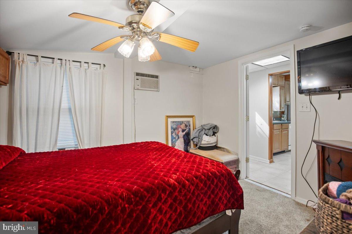 3330 1st Street Port Republic, MD 20676 - Photo 11 of 20 a bedroom with a bed and a chandelier
