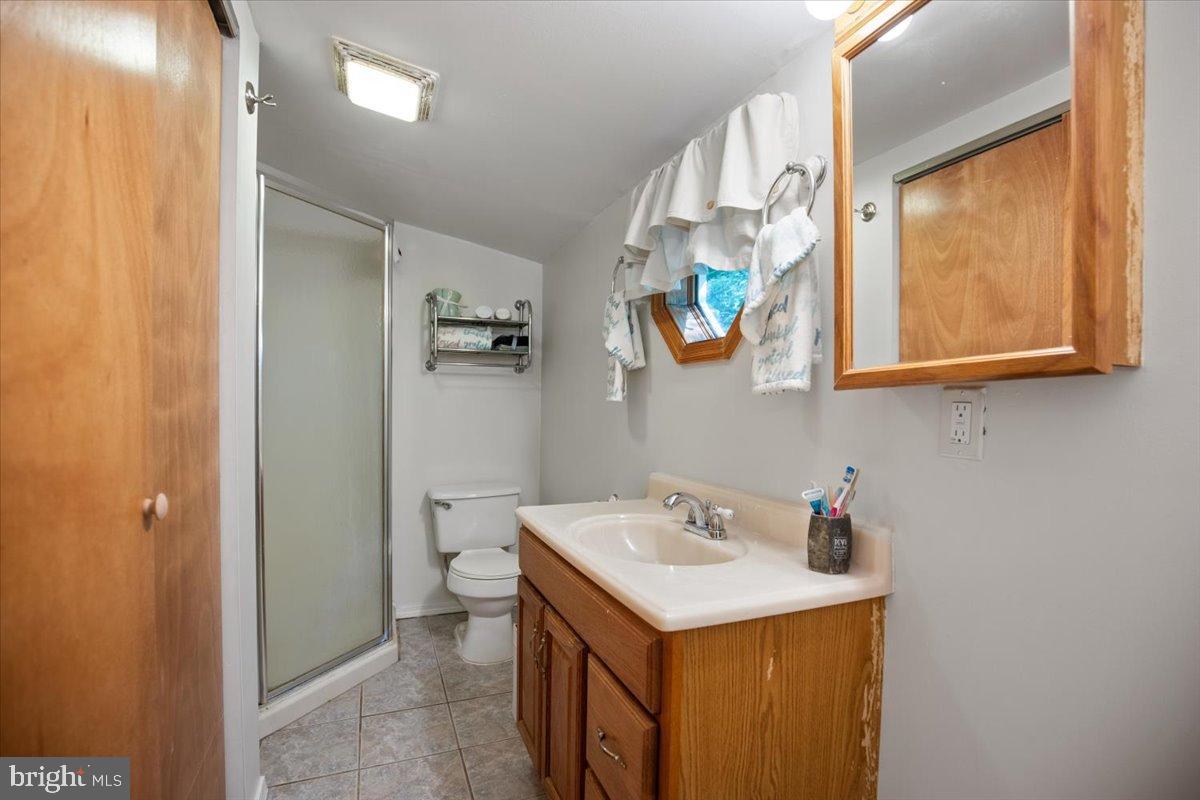 3330 1st Street Port Republic, MD 20676 - Photo 12 of 20 a bathroom with a sink and a mirror