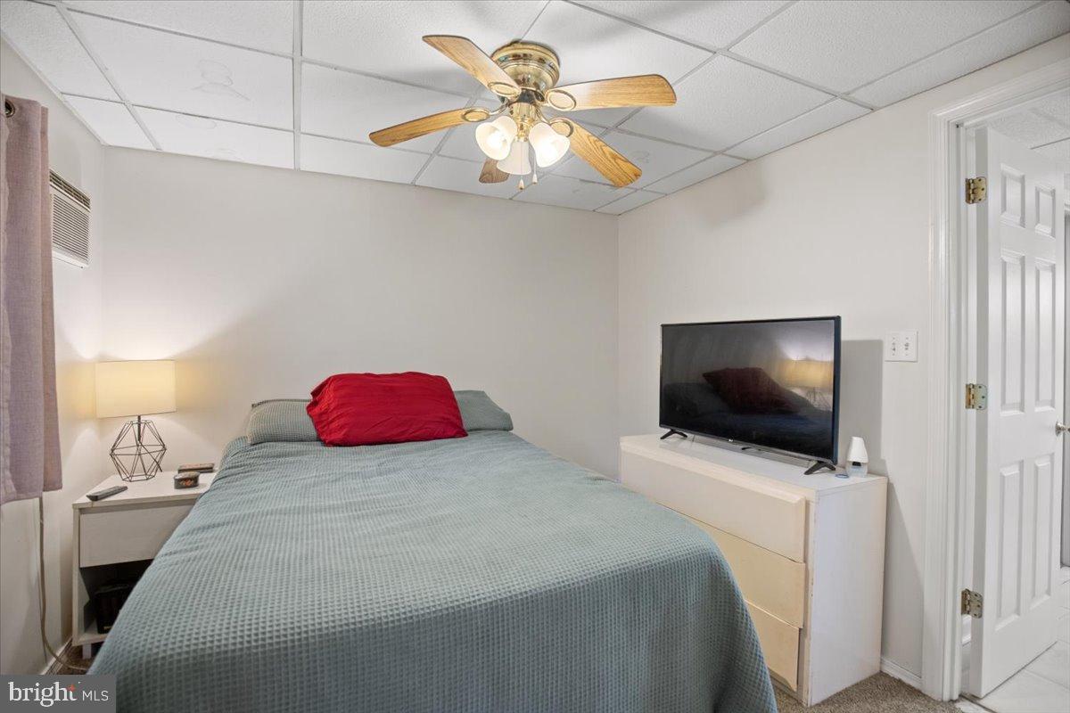 3330 1st Street Port Republic, MD 20676 - Photo 13 of 20 a bedroom with a bed and a flat tv screen on dresser