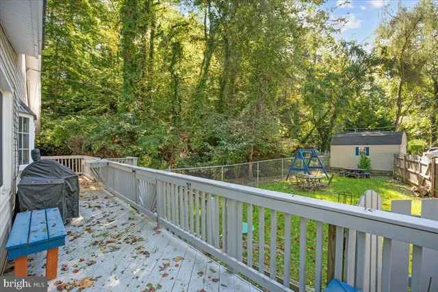 a backyard of a house with wooden floor and fence