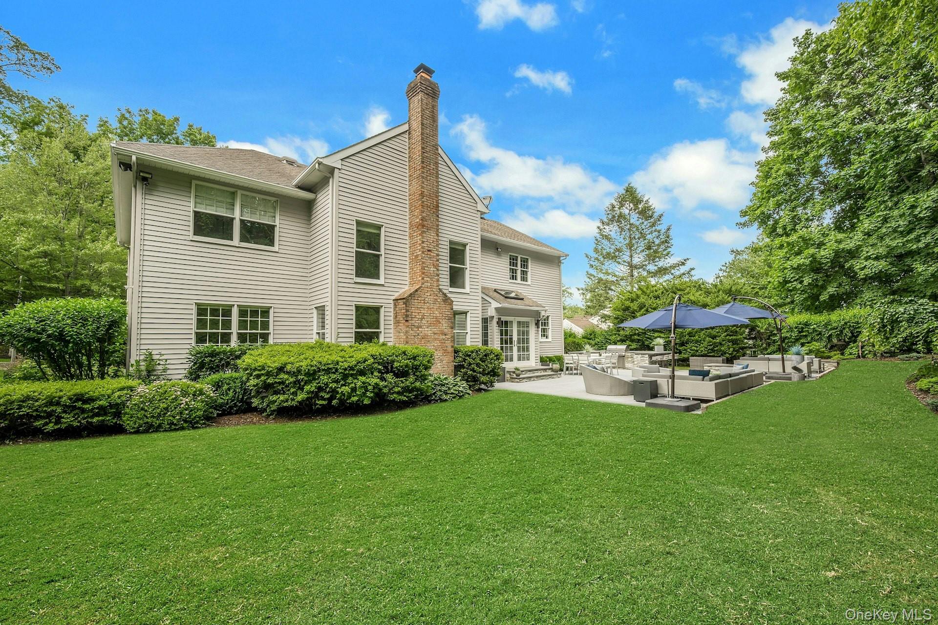 134 Euclid Avenue Ardsley, NY 10502 - Photo 37 of 48 Rear view of property featuring an outdoor patio and lawn