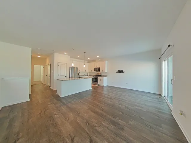 a view of large kitchen with a sink and a large window