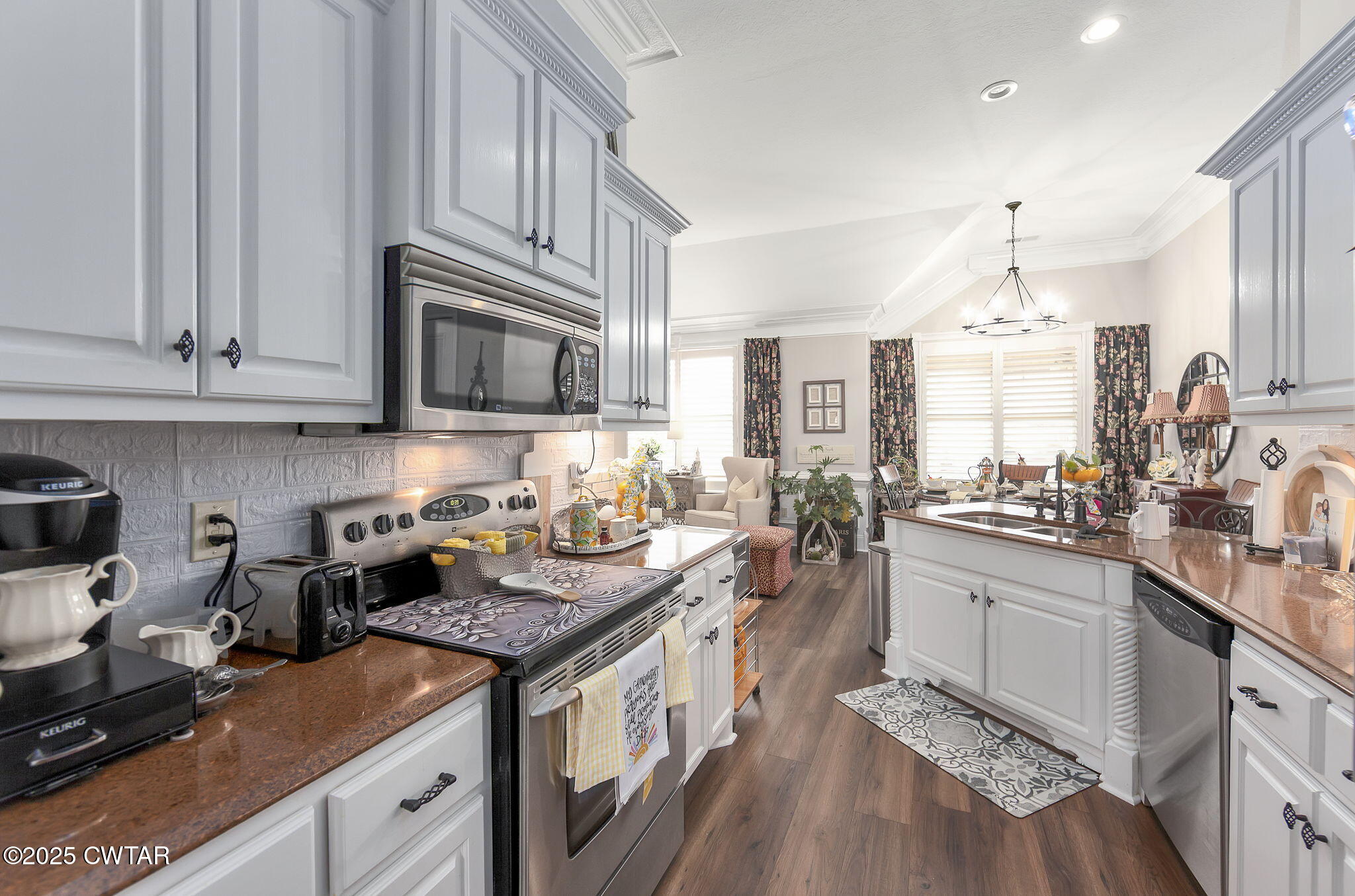 9 Dayton Cove Jackson, TN 38305 - Photo 12 of 27 a kitchen with stainless steel appliances granite countertop a stove a sink dishwasher and cabinets with wooden floor