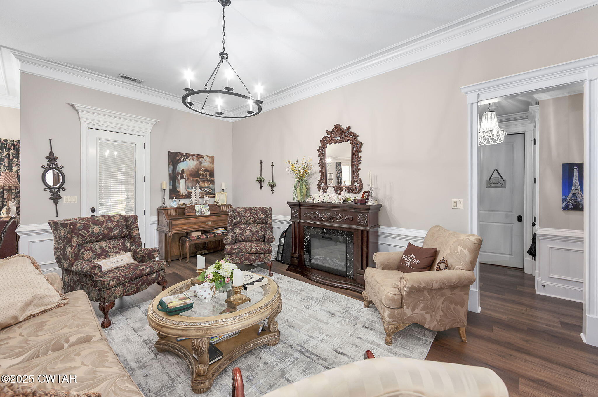 9 Dayton Cove Jackson, TN 38305 - Photo 16 of 27 a living room with furniture a fireplace and a chandelier