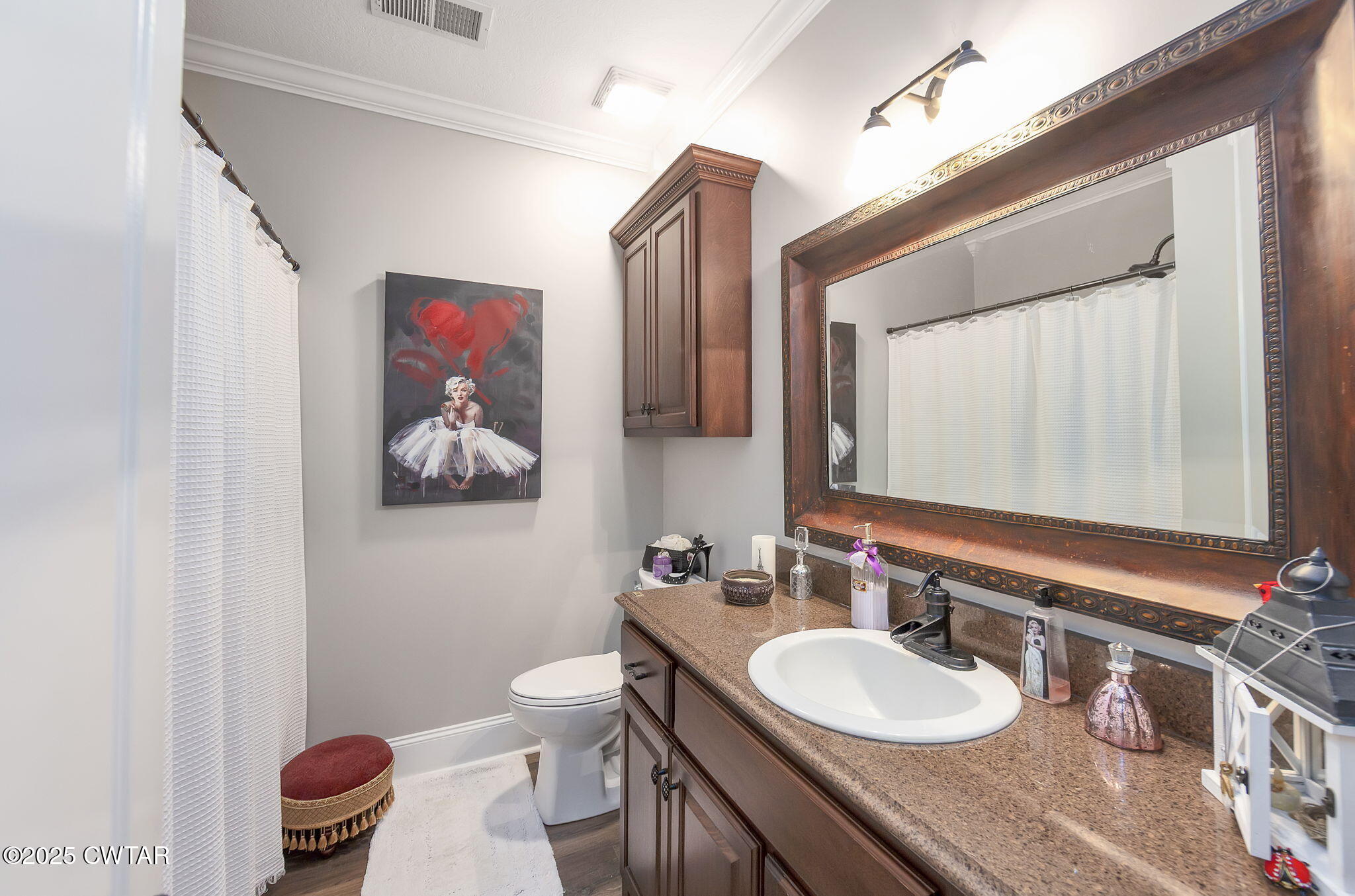 9 Dayton Cove Jackson, TN 38305 - Photo 25 of 27 a bathroom with a toilet a sink and a mirror