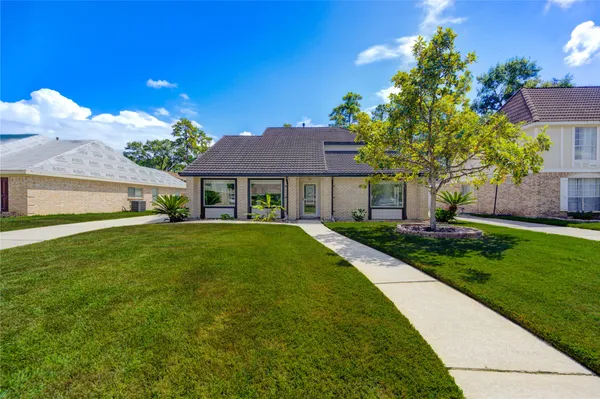 a view of house that has a yard