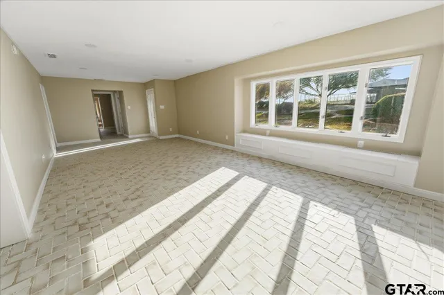 a spacious bathroom with a granite countertop sink mirror and bathtub