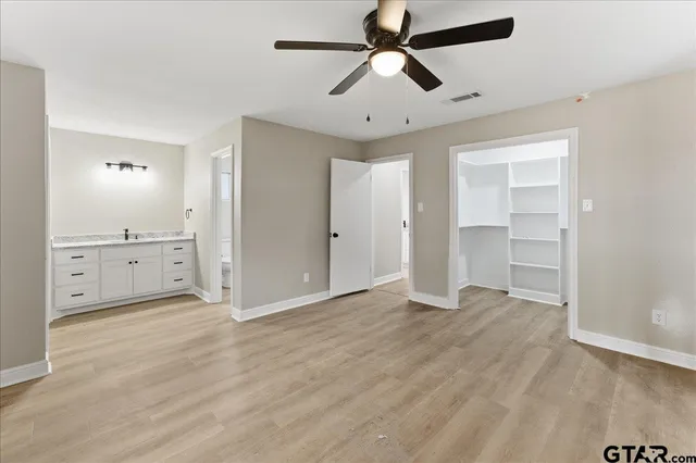 a spacious bathroom with a granite countertop sink mirror and