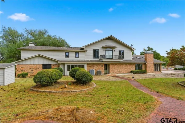 an aerial view of a house with a yard and lake view