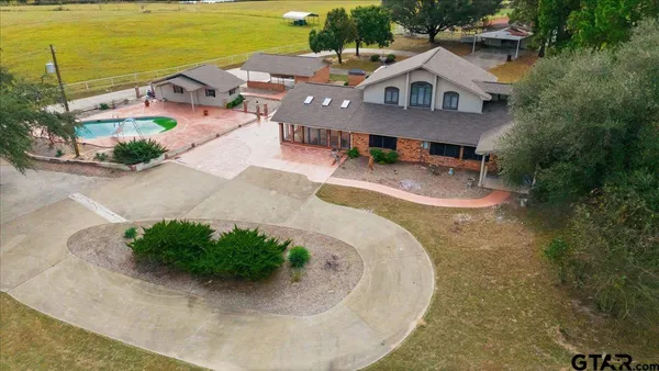 a view of a swimming pool with a yard and sitting area