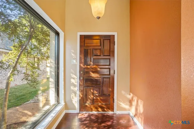 a view of a livingroom with a fireplace and a ceiling fan