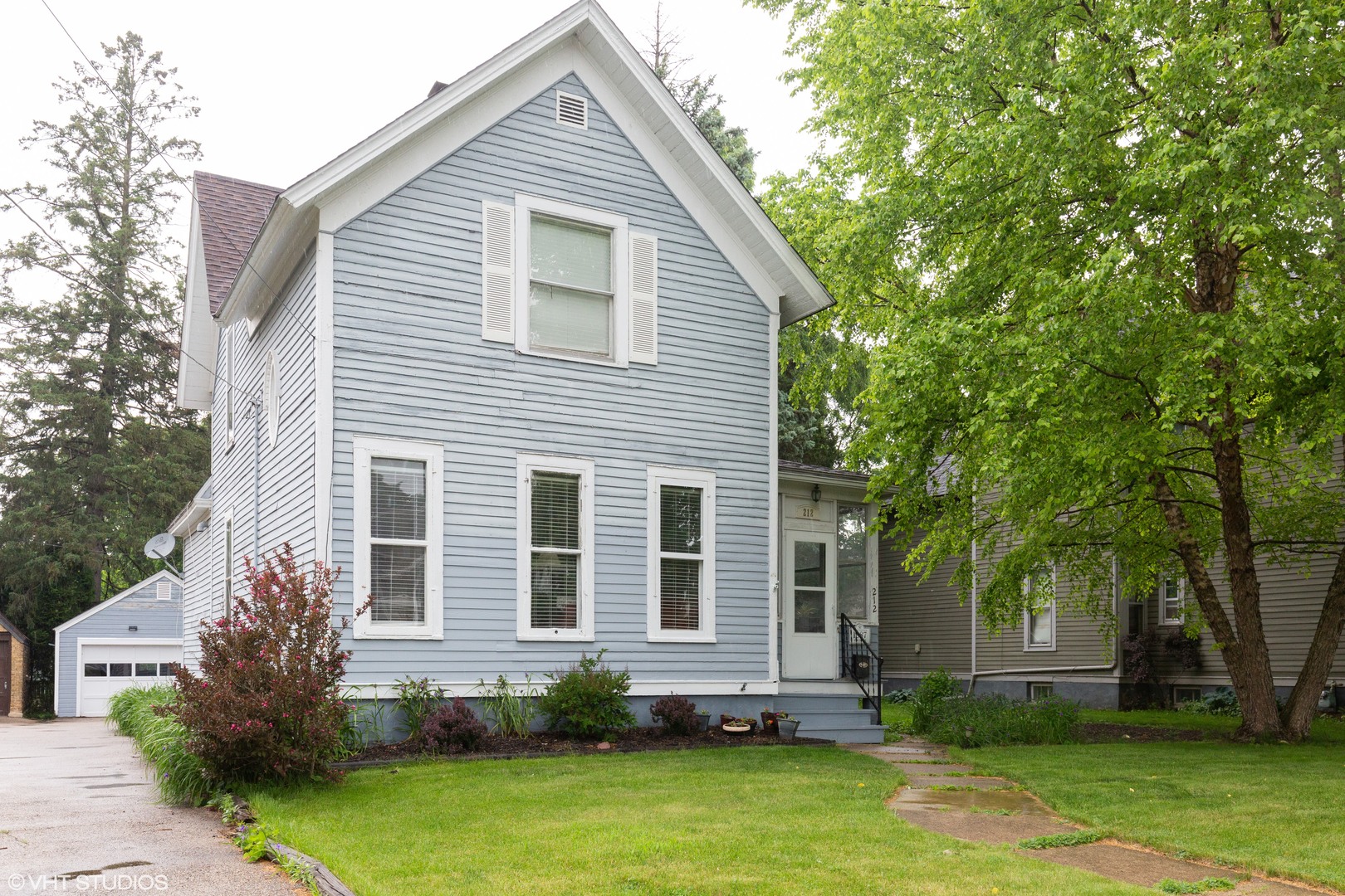 212 Lovell Street Elgin, IL 60120 - Photo 1 of 12 a front view of a house with a yard