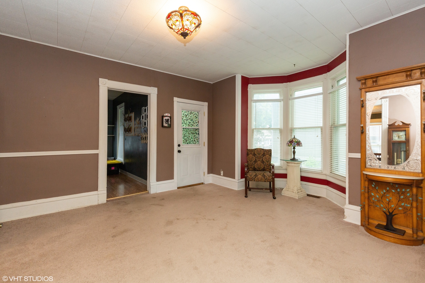 212 Lovell Street Elgin, IL 60120 - Photo 3 of 12 a view of an empty room with furniture and a window
