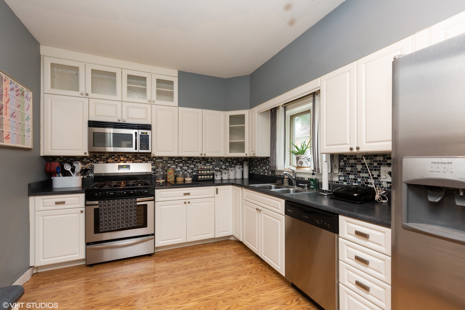 212 Lovell Street Elgin, IL 60120 - Photo 6 of 12 a kitchen with granite countertop a sink and cabinets