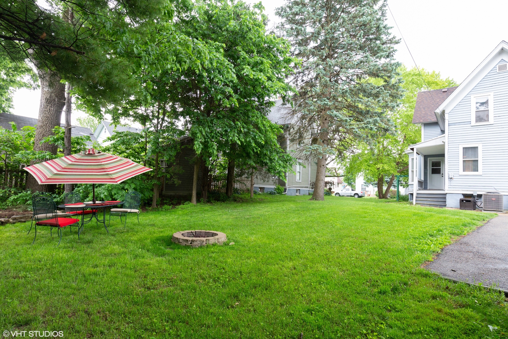 212 Lovell Street Elgin, IL 60120 - Photo 10 of 12 a view of a backyard with table and chairs and a fire pit