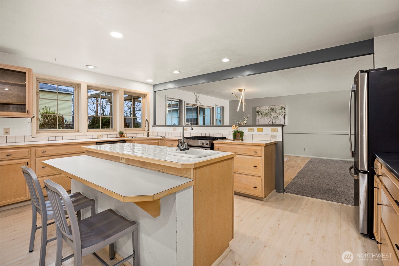 2935 King Street Bellingham, WA 98225 - Photo 14 of 38 a kitchen with a table chairs refrigerator and a sink