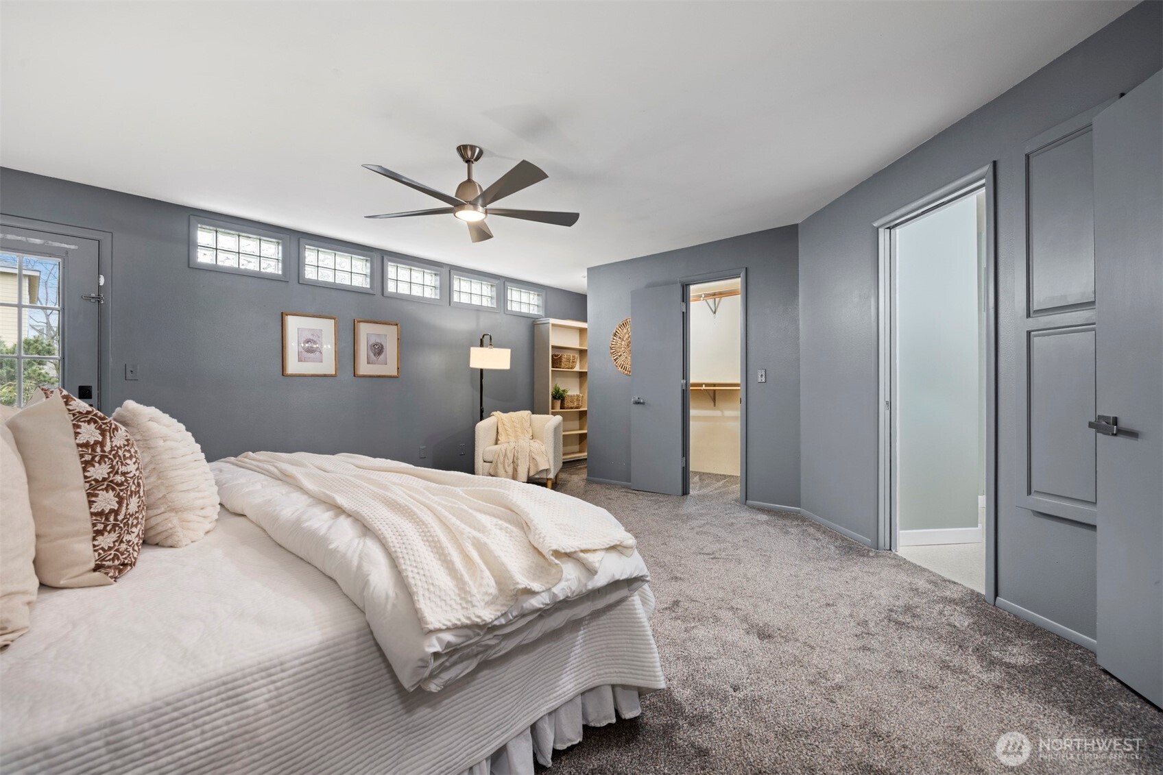 2935 King Street Bellingham, WA 98225 - Photo 19 of 38 a bedroom with a large bed and a chandelier