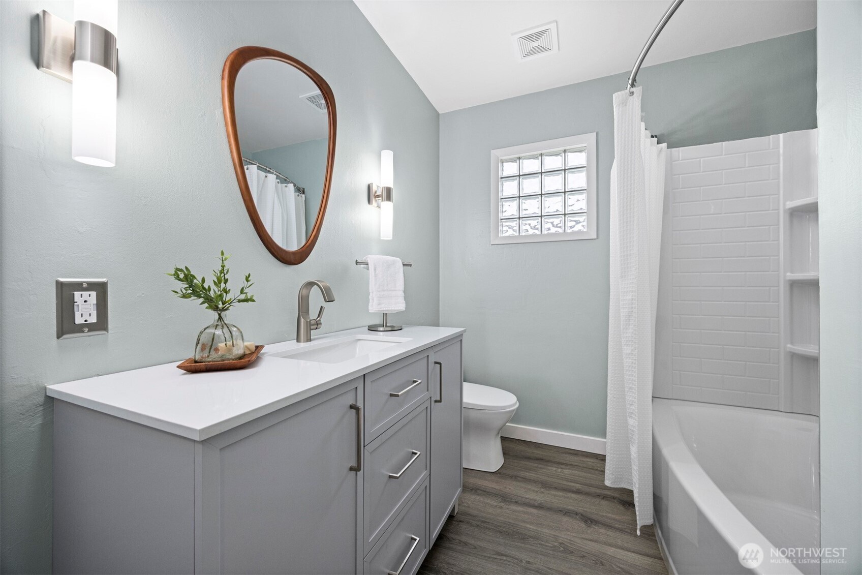 2935 King Street Bellingham, WA 98225 - Photo 25 of 38 a bathroom with a toilet a sink a mirror and a bathtub