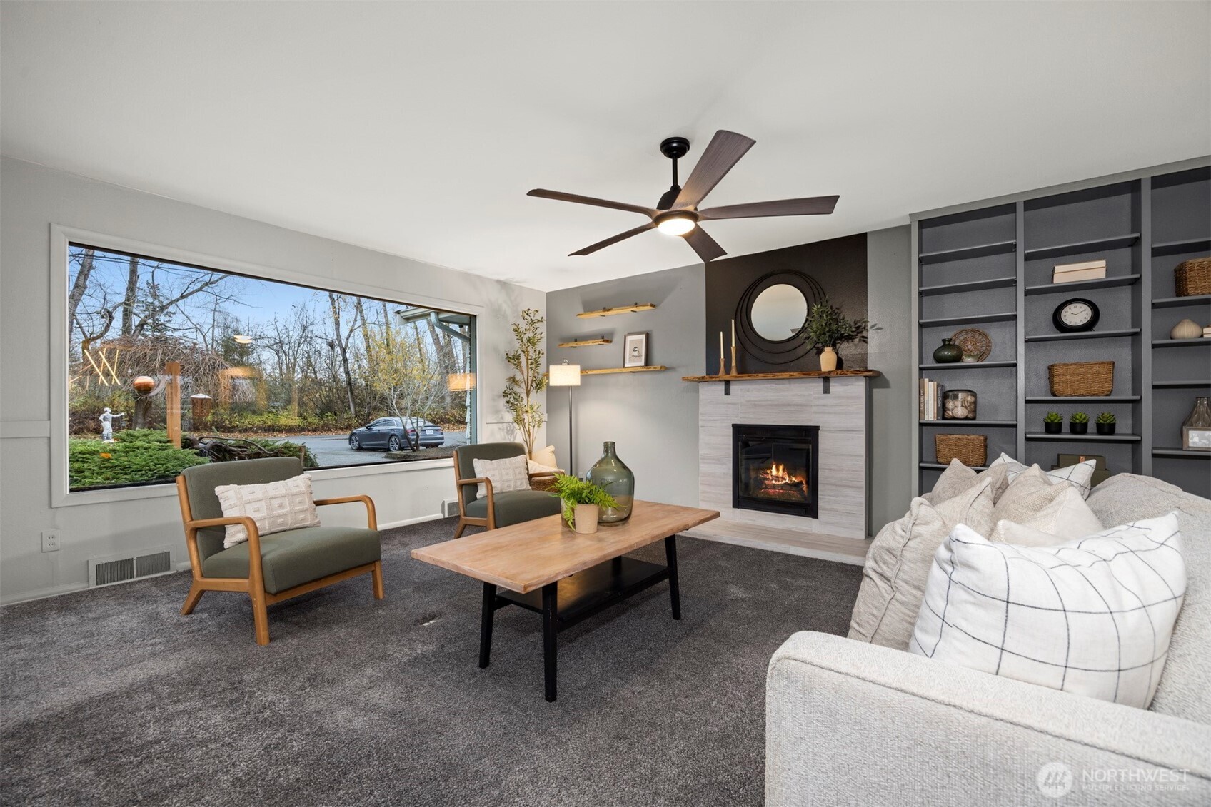 2935 King Street Bellingham, WA 98225 - Photo 8 of 38 a living room with furniture a fireplace and a large window