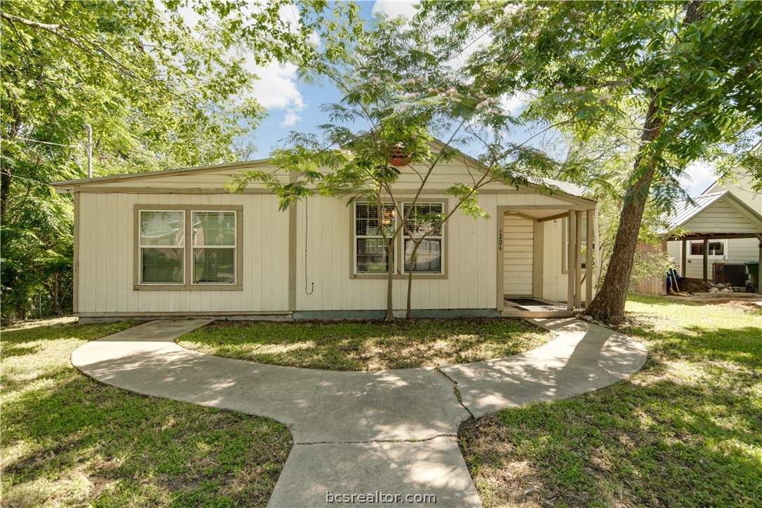 1204 East 28th Street Bryan, TX 77803 - Photo 1 of 22 a front view of a house with a yard and garage