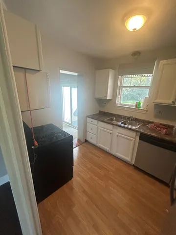 a kitchen with wooden floors and appliances