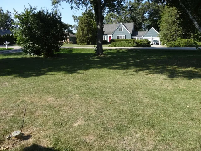 a view of a big house with a big yard