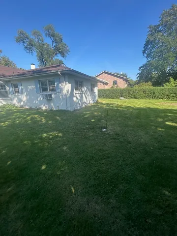 a view of an house with a big yard