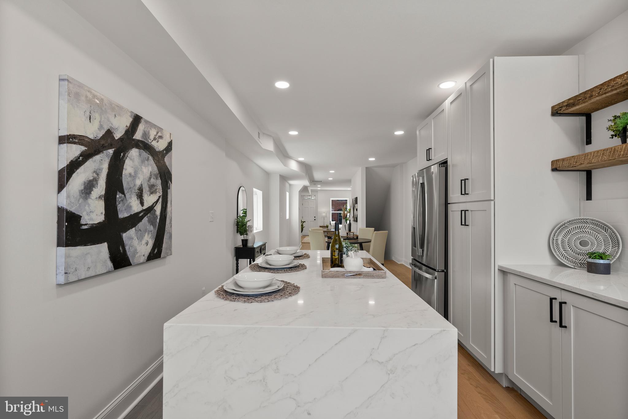 1523 Clarkson Street Baltimore, MD 21230 - Photo 20 of 57 a kitchen with stainless steel appliances kitchen island granite countertop a refrigerator and a stove