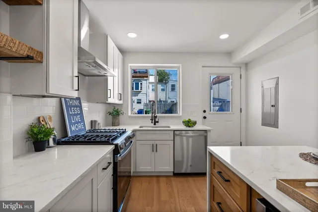 a kitchen with refrigerator and cabinets